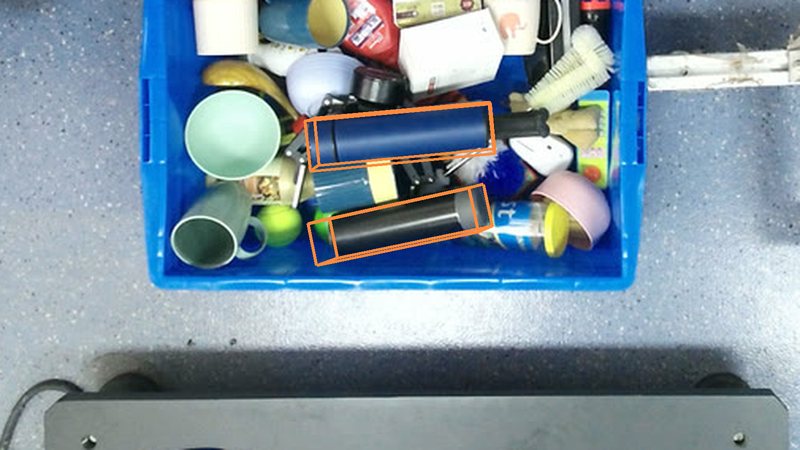 Two bottles in a crowded box with their ground-truth 3D boxes
