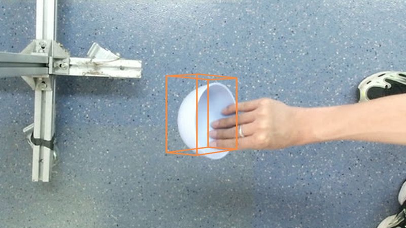 A tilted bowl held in a hand with its ground-truth 3D box