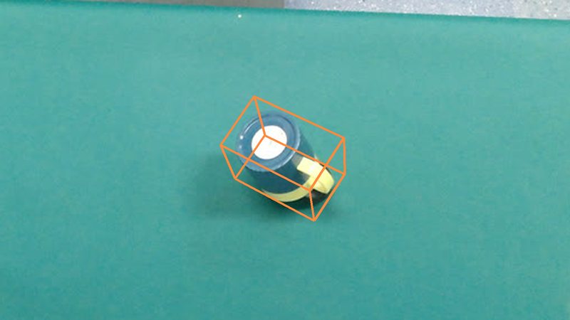 A mug lying on its side on a desk with its ground-truth 3D box
